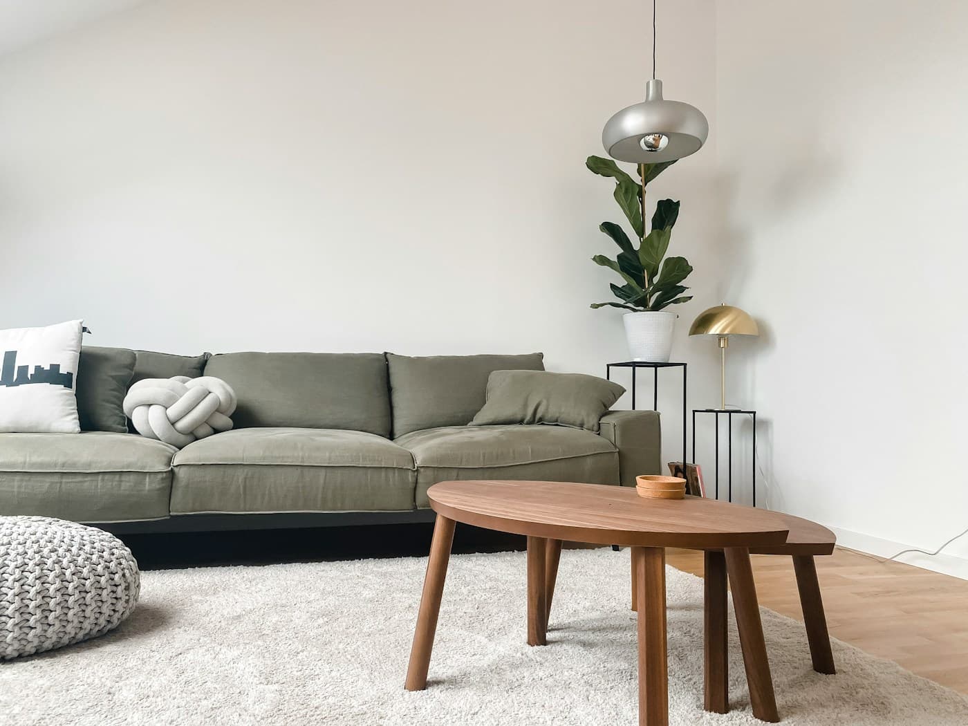 Cozy villa living room with a green sofa and warm wood floors